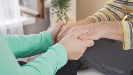Nurse-holding-hands-of-female-patient.Healthcare-support-concept.
